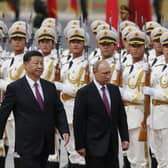 Russian President Vladimir Putin, right, and Chinese President Xi Jinping review an honor guard during a welcome ceremony outside the Great Hall of the People in Beijing two years ago.