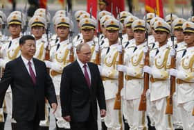 Russian President Vladimir Putin, right, and Chinese President Xi Jinping review an honor guard during a welcome ceremony outside the Great Hall of the People in Beijing two years ago.