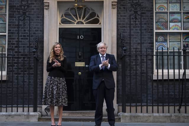 Boris Johnson and his partner Carrie Symonds take part in a 'Calp for Carers' celebration in 10 Downing Street.