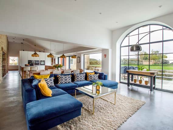 The open-plan living space is cleverly zoned with kitchen, dining, living areas