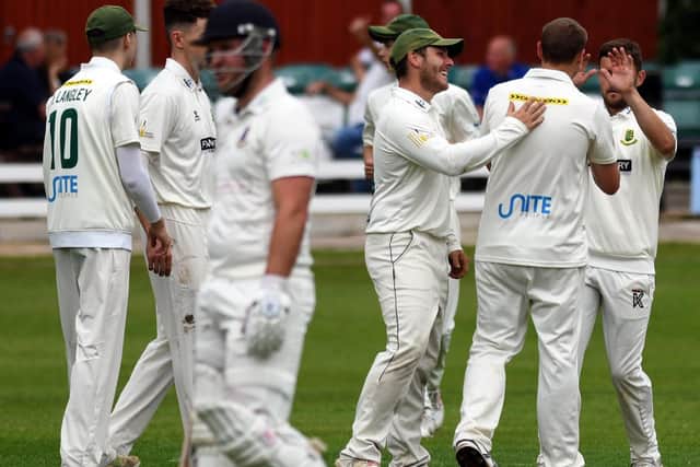 Out: New Farnley players celebrate the wicket of Joe Pyrah of Cleckheaton.