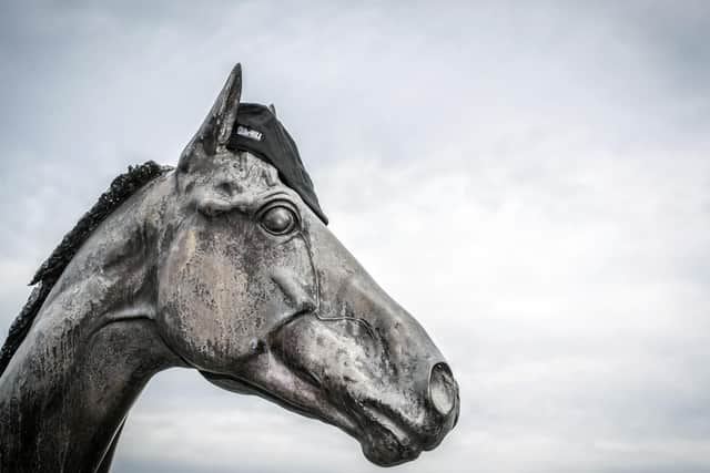 Statue to Double Trigger: Resplendent with a racegoer's cap, it stands at the entrance to Doncaster Racecourse where Mark Johnston's champion stayer excelled.