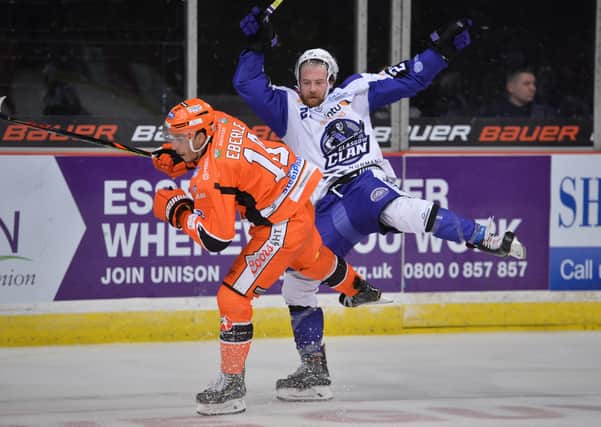 TAKE THAT: Tanner Eberle takes out Glasgow Clan's Linden Springer during an Elite League clash at Sheffield Arena last season. Picture: Dean Woolley.