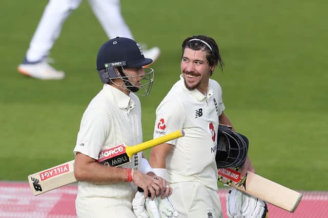 England's Joe Root (left) and Rory Burns leave the pitch after England declare following the dismissal of Burns for 90 on day three at Old Trafford. Picture: Martin Rickett/NMC Pool/PA