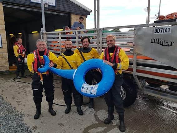 The rescue crew with the inflatable the girl was using