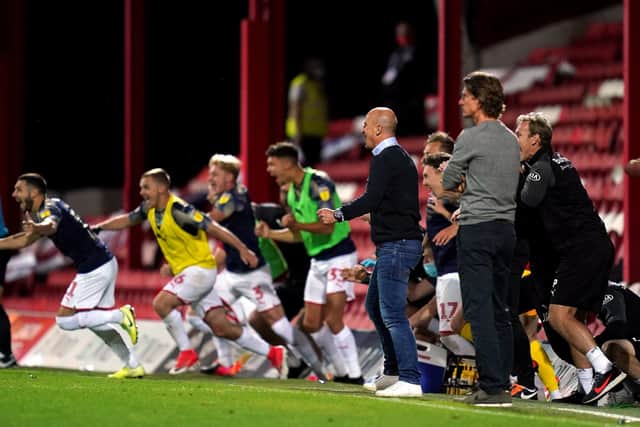 Barnsley manager Gerhard Struber and his players celebrate at the final whistle as Brentford manager Thomas Frank looks on after the Sky Bet Championship match at Griffin Park, London. PA Photo. Picture date: Wednesday July 22, 2020. See PA story SOCCER Brentford. Photo credit should read: John Walton/PA Wire. RESTRICTIONS: EDITORIAL USE ONLY No use with unauthorised audio, video, data, fixture lists, club/league logos or "live" services. Online in-match use limited to 120 images, no video emulation. No use in betting, games or single club/league/player publications.