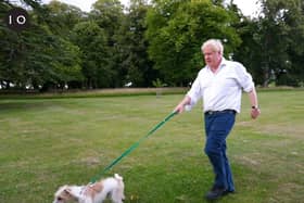 Boris Johnson takes his dog Dilyn for a walk at the start of a new campaign on obesity. Photo: 10 Downing Street.