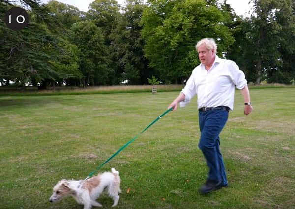 Boris Johnson takes his dog Dilyn for a walk at the start of a new campaign on obesity. Photo: 10 Downing Street.