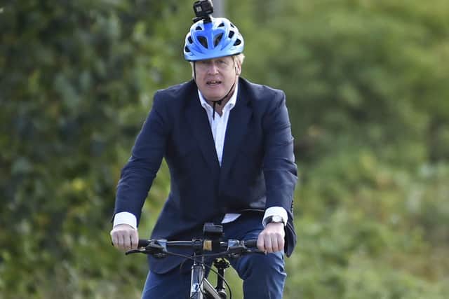 Prime Minister Boris Johnson rides a bicycle during a visit to the Canal Side Heritage Centre in Beeston near Nottingham to launch of a strategy to get more people cycling.