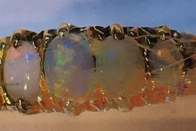 A five-stone opal ring was stolen in the burglary