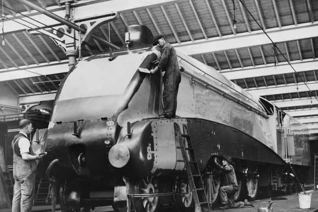 The LMS ( London Midland and Scottish Railway) Sir Nigel Gresley designed Jubilee Class 5552 Silver Jubilee 4-6-0 express steam locomotive with A4-style streamlining being painted at the Doncaster railway works on 31 October 1935  in Doncaster, United Kingdom.  (Photo by Harry Todd/Fox Photos/Hulton Archive/Getty Images).
