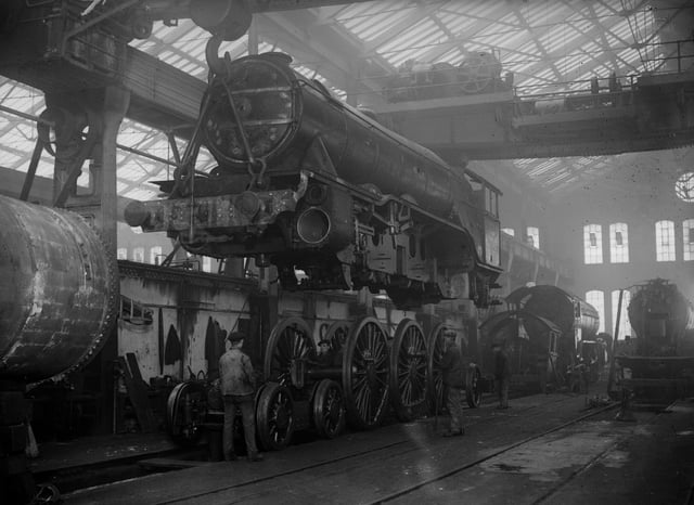 31st January 1931:  A locomotive being lifted on to its wheels at the LNER works, Doncaster.  (Photo by Fox Photos/Getty Images)