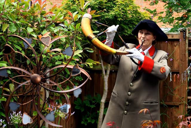 Allison Clark one of the Ripon hornblowing team keeping the tradition going by blowing the 1690 horn in her Ripon garden. Image: Gary Longbottom