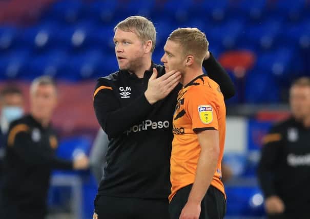 Coach Grant McCann consoles Keane Lewis-Potter after Hull City were relegated to League One earlier this month. Picture: PA.