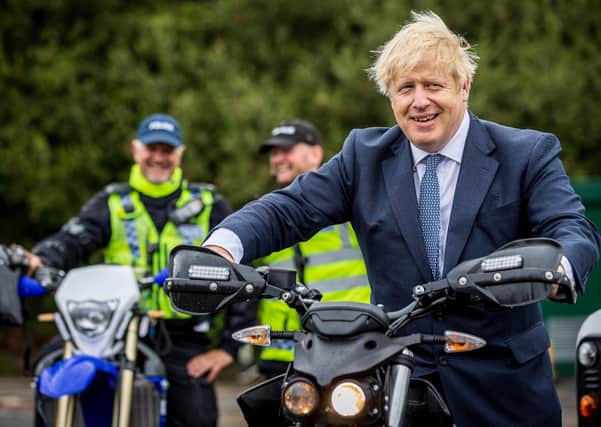 Prime Minister Boris Johnson tries out a North Yorkshire Police Rural Taskforce bike which is a Zero FX an Electric Bike during a visit to North Yorkshire Police headquarters, Northallerton.