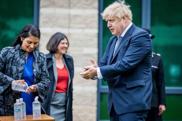 Prime Minister Boris Johnson and Home Secretary Priti Patel using antiseptic hand gel during a visit to North Yorkshire Police headquarters, Northallerton. In the background is Julia Mulligan, the North Yorkshire crime commissioner.