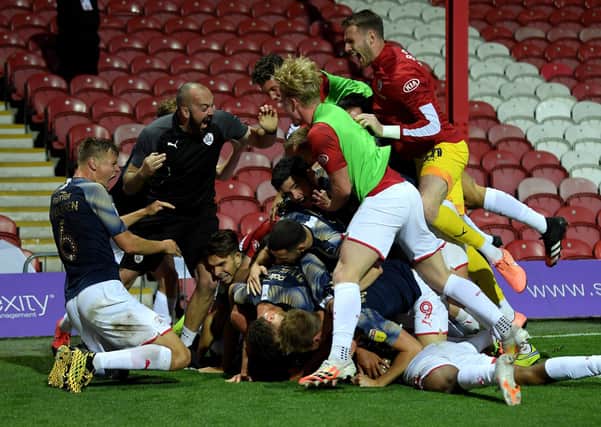 MAGIC MOMENT: Clarke Oduor of Barnsley celebrate with hos team mates after he scores his team's winning goal against Brentford at Griffin Park. Picture: Mike Hewitt/Getty Images
