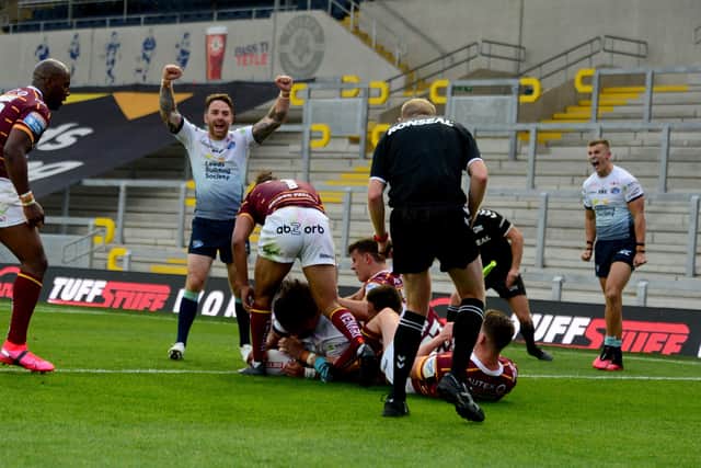 OVER THE LINE: Leeds Rhinos' players celebrate after Konrad Hurrell scores a late try. Picture: James Hardisty.