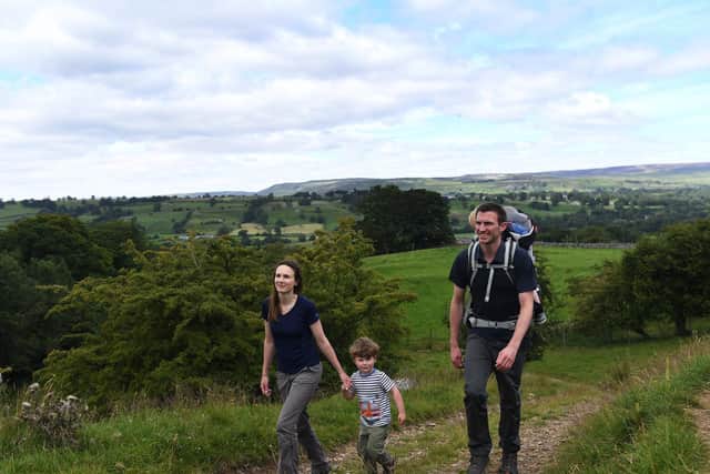 Matt and Helen Coppin from West Burton are combining their knowledge of the Yorkshire Dales and love of hiking to run a new self-guided walking holiday company called Muddy Boots Walking Holidays. Pictured with their sons Ed, three, and Tom, one. Picture: Jonathan Gawthorpe
