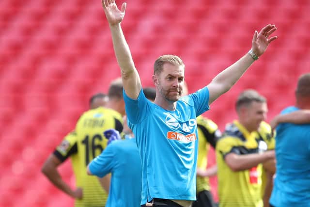 Harrogate Town manager Simon Weaver celebrates his club's promotion to the Football League.