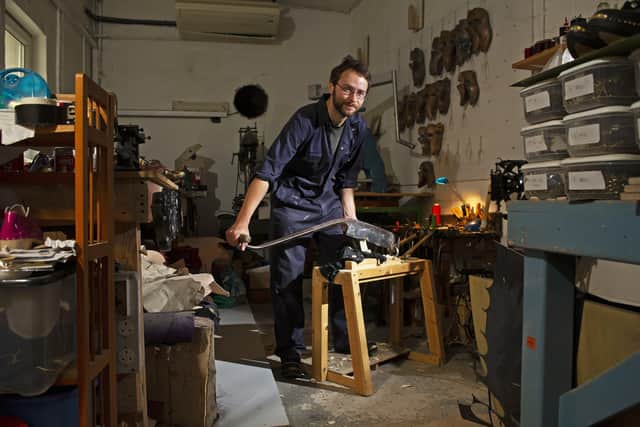 British clog maker Simon Brock working in his Sheffield workshop.  Simon forms the shape of the soles made from sycamore using a clog knife.  Picture Tony Johnson
