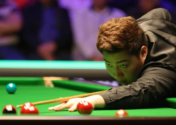 Yan Bingtao in action today against Judd Trump. Photo: Nigel French/PA Wire
