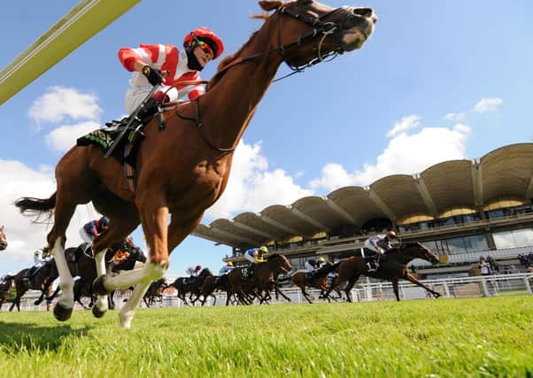 Summerghand ridden by Daniel Tudhope (right) wins the Unibet Stewards' Cup at the Goodwood Festival.