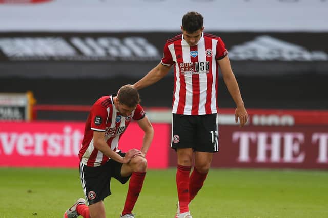 Chris Basham of Sheffield United is consoled by fellow defender John Egan (Picture: SportImage)
