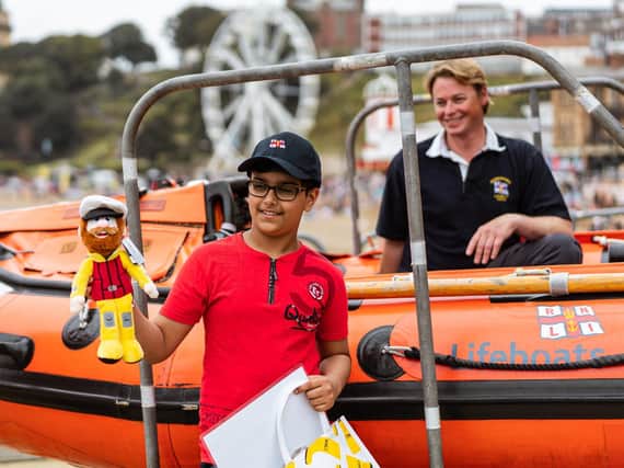 Ravi Saini, 10, from Leeds, during a visit to Scarborough lifeboat station to thank them after they rescued him