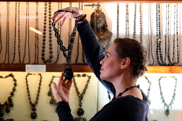 Careful study: Rebecca Tucker examines pieces of jet and jewellery in the shops workshop. Photo: Simon Hulme