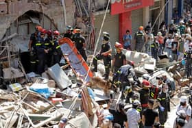 French and Lebanese firemen search in the rubble of a building after the Tuesday explosion at the seaport of Beirut, in Beirut, Lebanon, Thursday, August 6, 2020.  (AP Photo/Hassan Ammar).