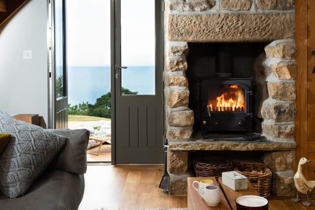 A new French door brings views into the property and a wood-burning stove keeps it cosy.