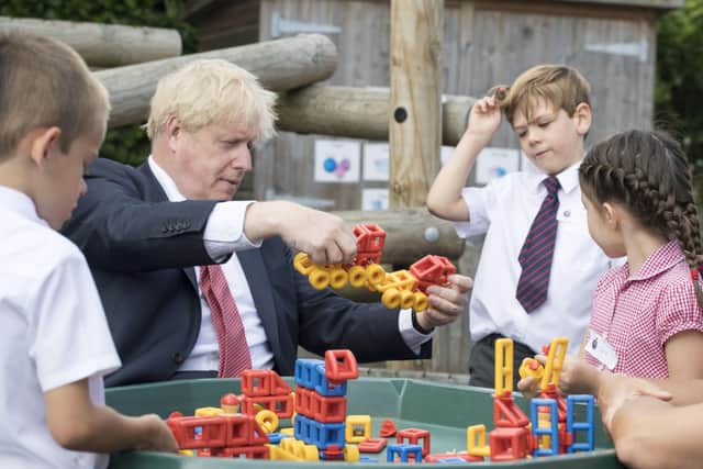 Prime Minister Boris Johnson joins children playing with construction toys during a visit to The Discovery School in West Malling, Kent.  Picture: Jeremy Selwyn/Evening Standard/PA Wire