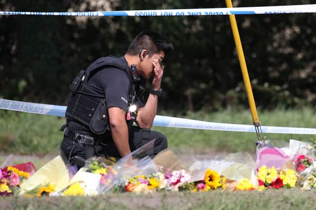 A police officer paying his respects at the scene near Ufton Lane, Sulhamstead, Berkshire, where Thames Valley Police officer Pc Andrew Harper, 28, died. Picture: Andrew Matthews/PA Wire