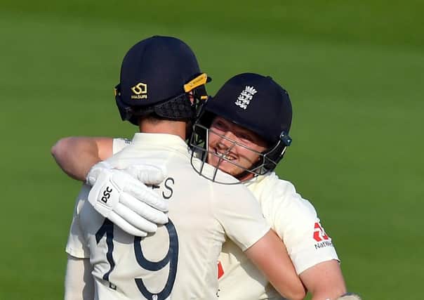 Done it: England's Chris Woakes, left, and Dom Bess celebrate victory. Pictures: Dan Mullan/PA