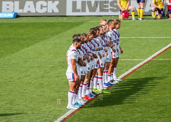 Making a stand: Wakefield players decided to stand, rather than take a knee before the defeat against Wigan. (Picture: Alex Whitehead/SWpix.com)