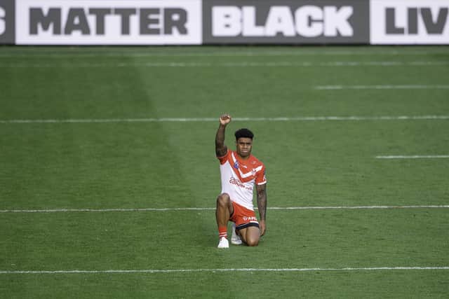 St Helens's Kevin Naiqama raises his fist in solidarity with Black Lives Matter prior to kick off against Leeds Rhinos. (Picture: Allan McKenzie/SWpix.com)