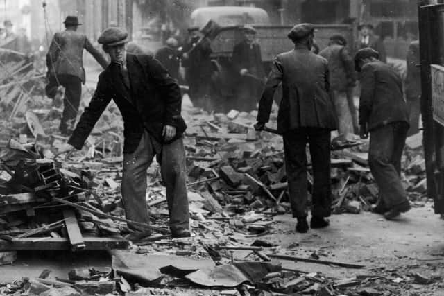 Men clean up the ruins left by a bombing in York