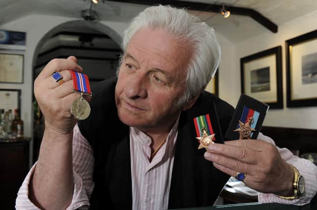 Ashley Jackson with his father's medals.