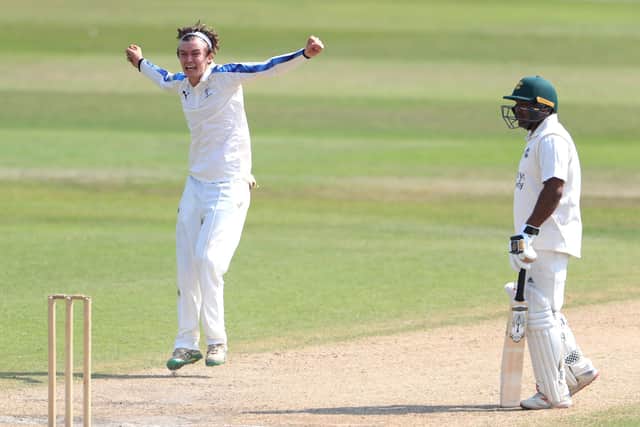 Yorkshire's Jack Shutt (left) celebrates taking the wicket of  Nottinghamshire's Peter Trego.