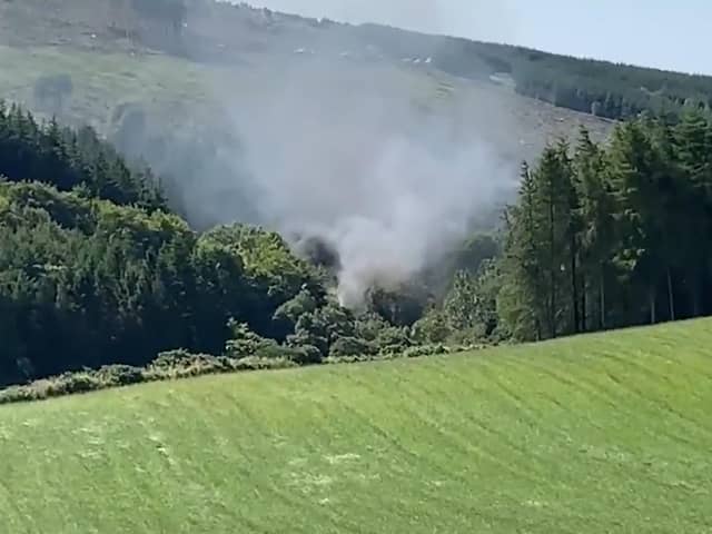A screen grab from BBC Scotland showing smoke billowing from the train on the track in the countryside near Stonehaven, Aberdeenshire.