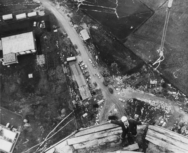 1970:One of the men with a head for heights at Emley Moor is Mr. Fred Price, who is in charge of site construction on the new TV mast.This picture, taken at a height of 910ft. from the top of the tower, gives the impression of an aerial view.