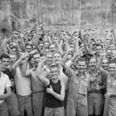 Allied prisoners of war celebrating their liberation from Changi Jail, Singapore.