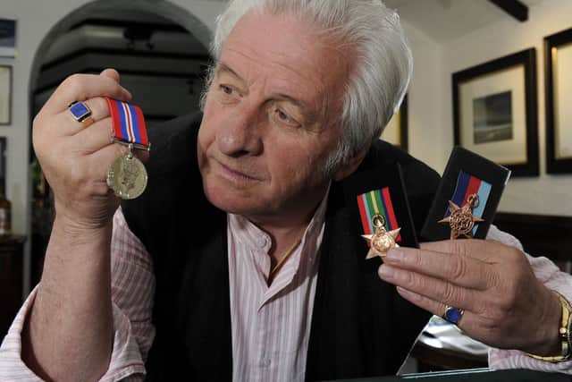 Ashley Jackson with his fathers war medals in 2015. (Bruce Rollinson).