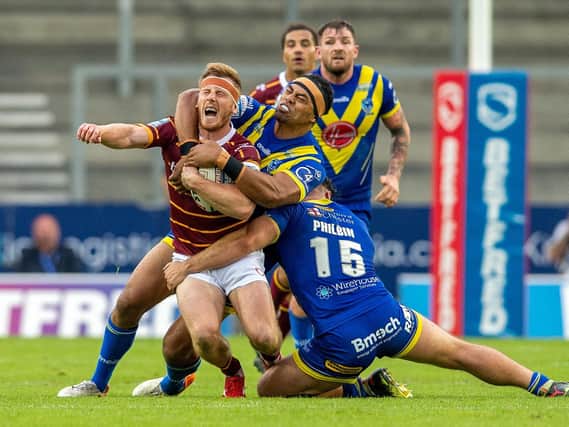 Huddersfield Giants' Adam O'Brien feels the pain from a high tackle. (PIC: Bruce Rollinson/JPIMedia)