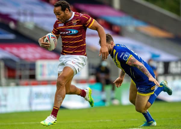 He's bacK: Leroy Cudjoe gets away from the Warrington Wolves defence.  Pictures: Bruce Rollinson
