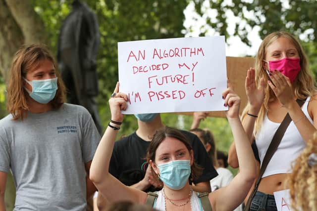 People take part in a peaceful protest in Parliament Square, London, in response to the downgrading of A-level results.
