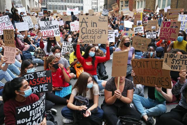 People take part in a protest outside the Department for Education, London, in response to the downgrading of A-level results. Photo: Jonathan Brady/PA Wire