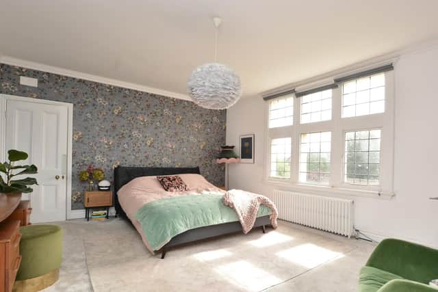 A bedroom with House of Hackney's Tulipa wallpaper and Vita feather light from Dowsing and Reynolds