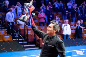 Back on top: Ronnie O’Sullivan holds aloft the Betfred World Championship trophy for the sixth time in his career in front of the few hundred or so fans permitted into the Crucible last night.  (Picture: Benjamin Mole/WST/Shutterstock)
